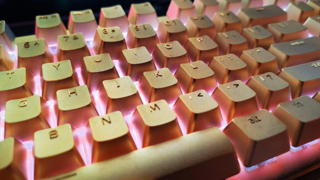 Image of the ADATA Golden Summoner Keyboard, a luxury gaming keyboard with a sleek black and gold design and RGB backlighting.